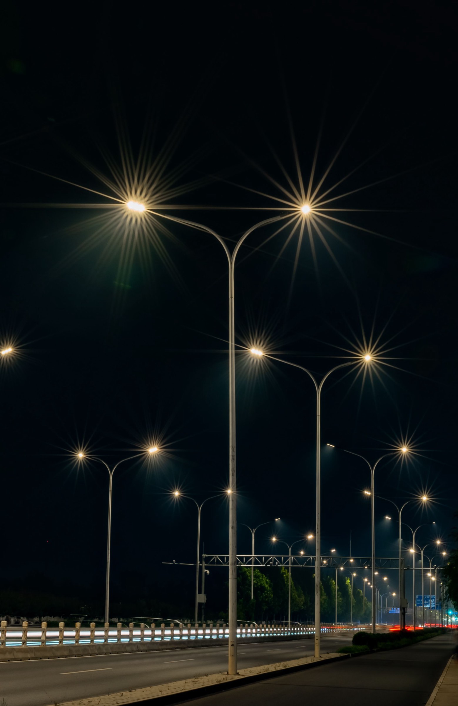 A run of highway streetlights at night
